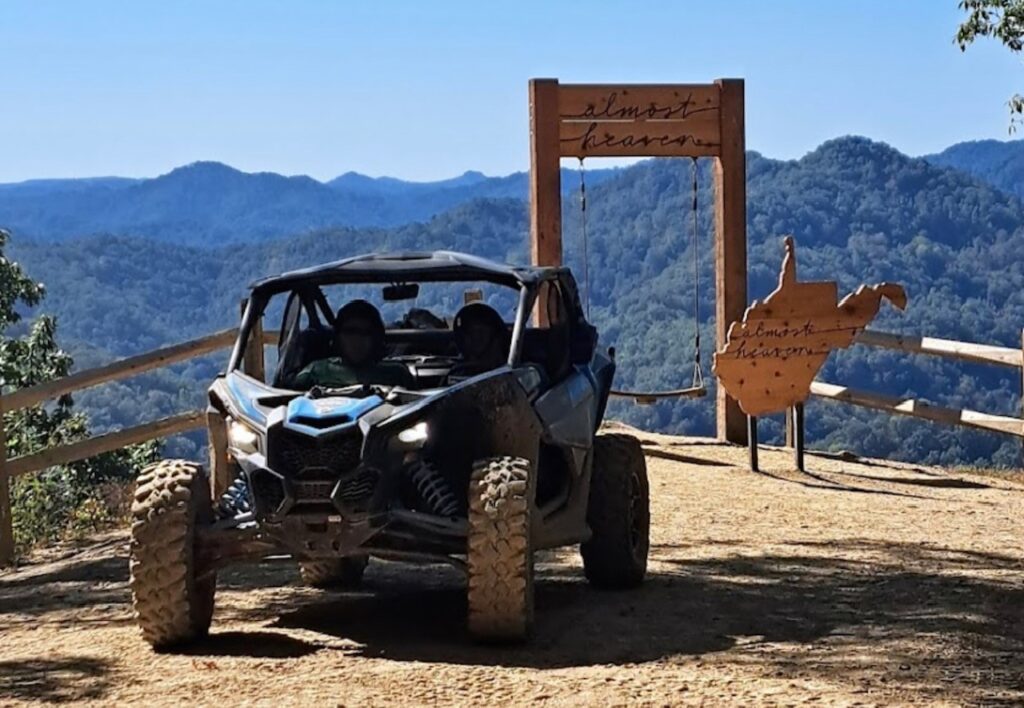 A can - am maverick xt parked on a dirt road.